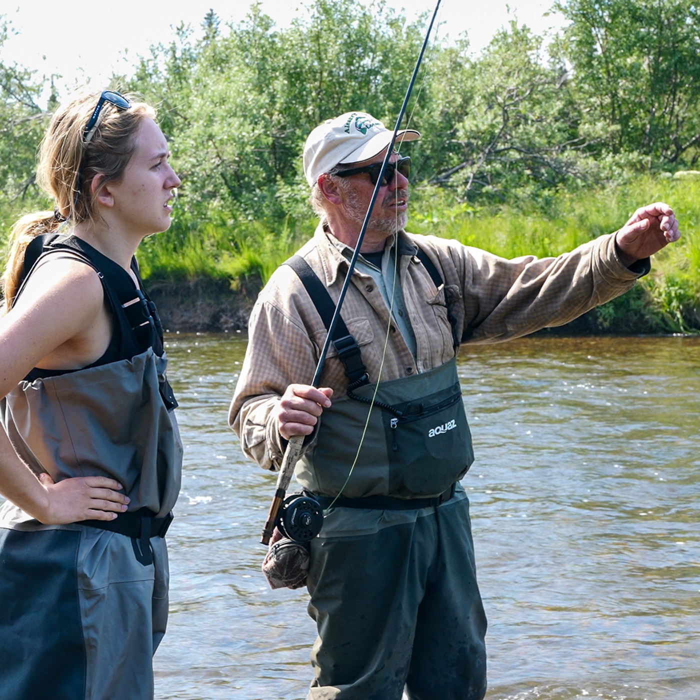 Legend Lodge owner Jack coaching a first-time fly angler on the riverbank