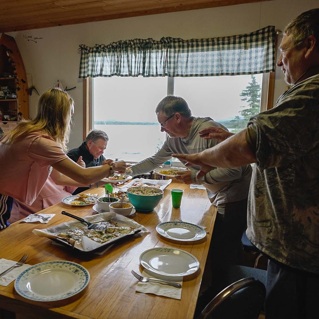 Guests sharing a home cooked meal and stories at Legend Lodge